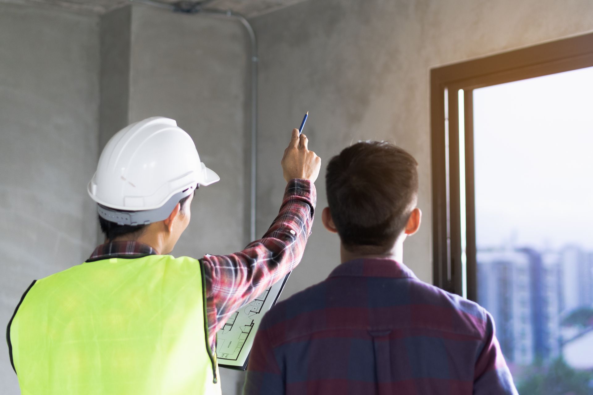 Workers discussing project in unfinished building